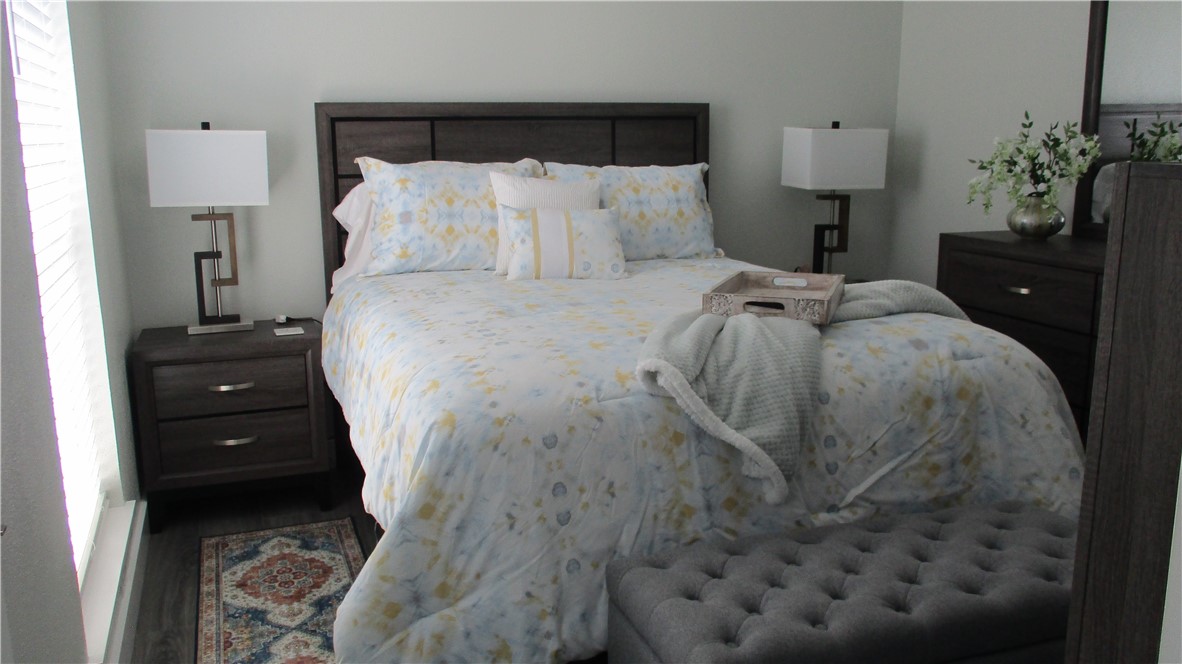 6702 Everhart Road, Unit H109 Corpus Christi, TX 78413 - Photo 12 of 18 a bed room with a bed and a potted plant