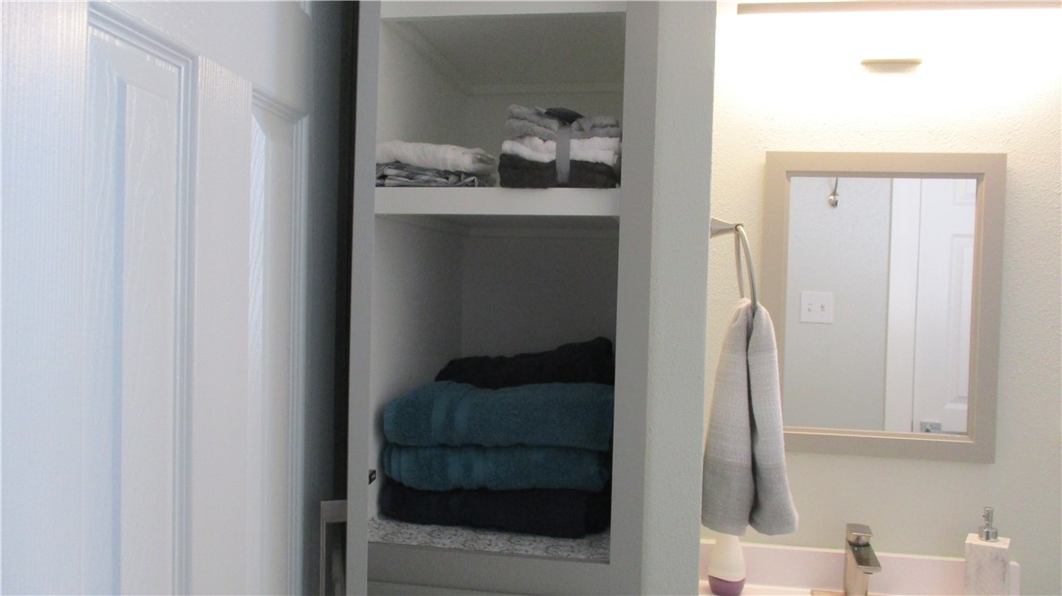 6702 Everhart Road, Unit H109 Corpus Christi, TX 78413 - Photo 15 of 18 a bathroom with a sink and mirror