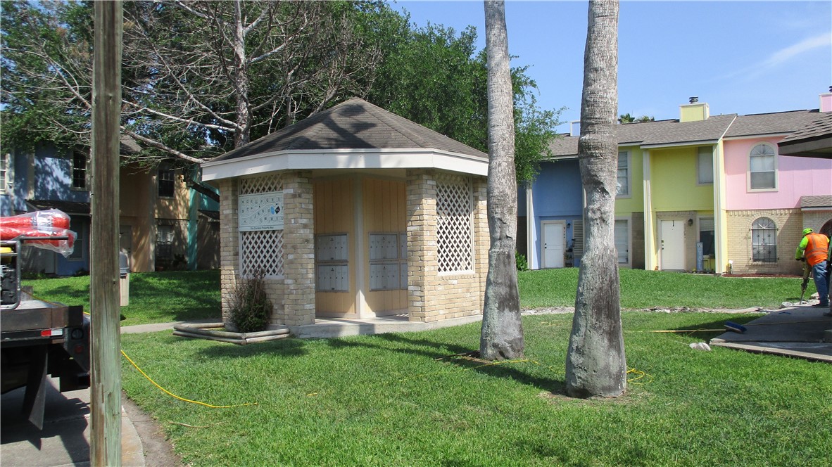6702 Everhart Road, Unit H109 Corpus Christi, TX 78413 - Photo 18 of 18 a front view of a house with a garden