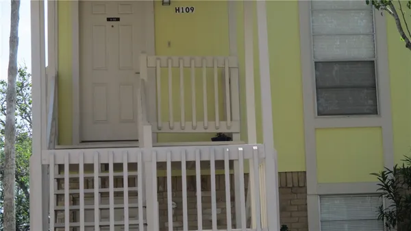 a view of a house with a wooden fence