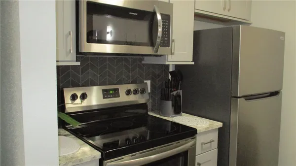 a kitchen with a stove and a microwave