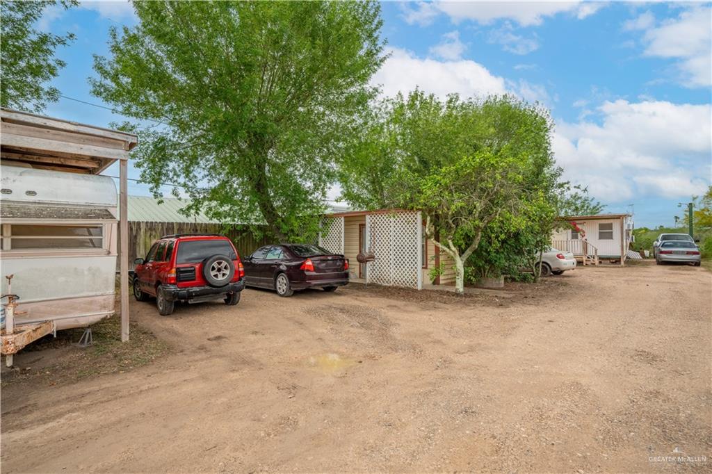 106 South Arroyo Boulevard Rio Hondo, TX 78583 - Photo 11 of 18 a view of a cars park in front of a house