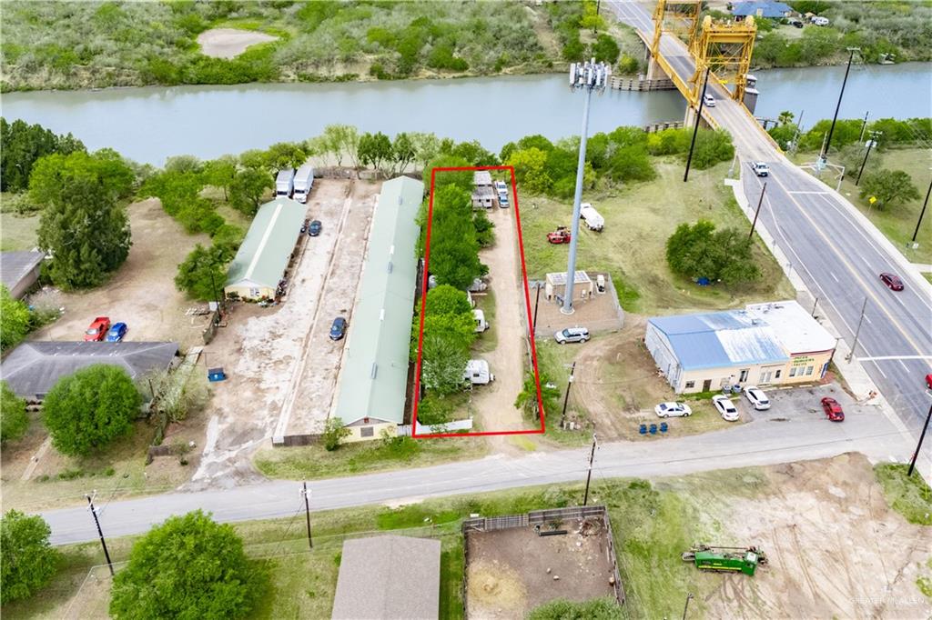 106 South Arroyo Boulevard Rio Hondo, TX 78583 - Photo 3 of 18 an aerial view of a house with a garden and lake view