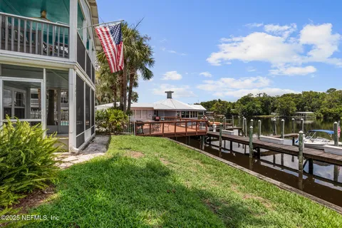 a view of a house with a yard and sitting area