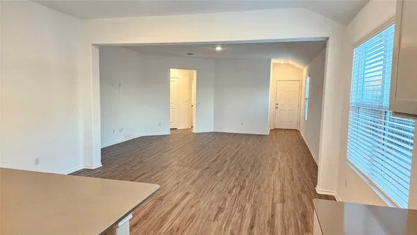 a view of a kitchen with wooden floor and a sink