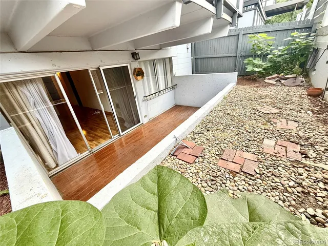 a view of empty room with wooden floor and fireplace