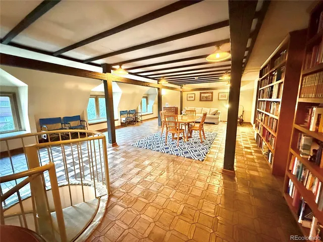 a living room with furniture a fireplace and a dining table with a fireplace