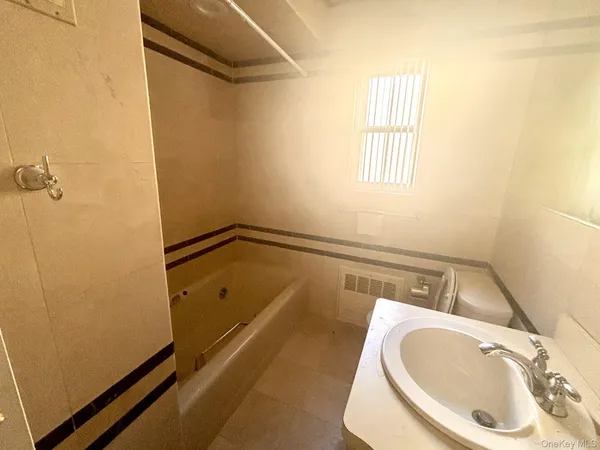 a bathroom with a tub and sink