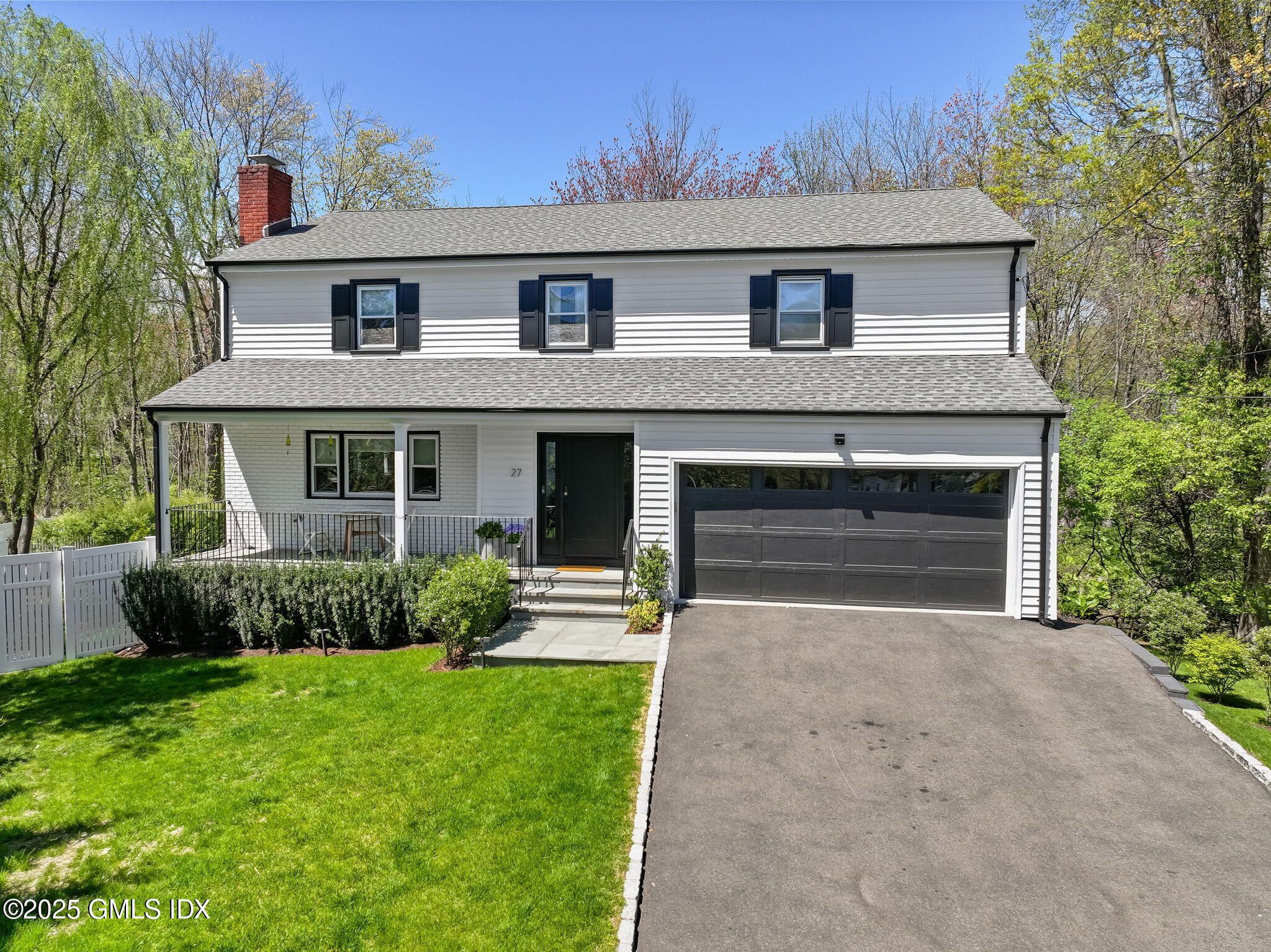 27 Griffith Road Riverside, CT 06878 - Photo 1 of 1 a front view of a house with a yard and garage