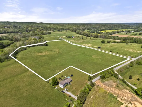 a view of a field with an ocean view