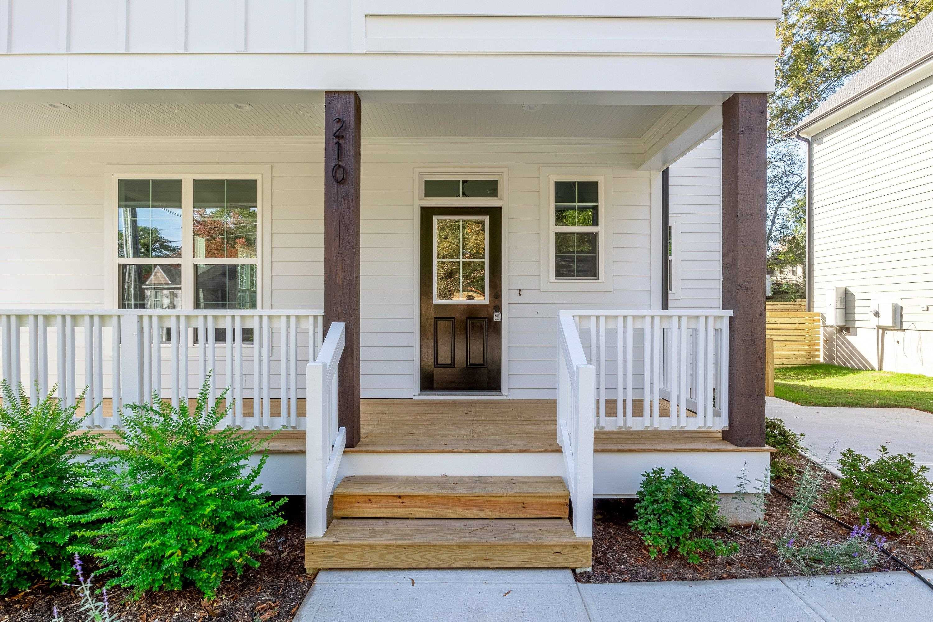 210 Knowles Street Raleigh, NC 27603 - Photo 5 of 65 a front view of a house with a garden
