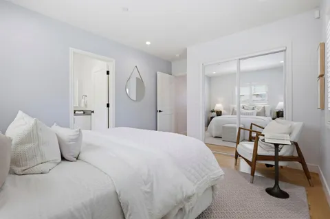 a bedroom with a bed a table and chair