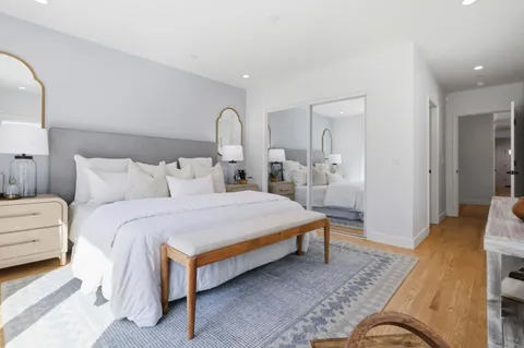 a bedroom with bed and a night stand