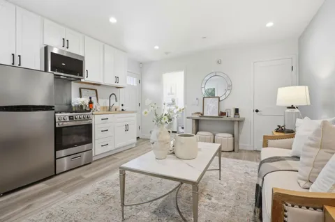 a kitchen with white cabinets and stainless steel appliances