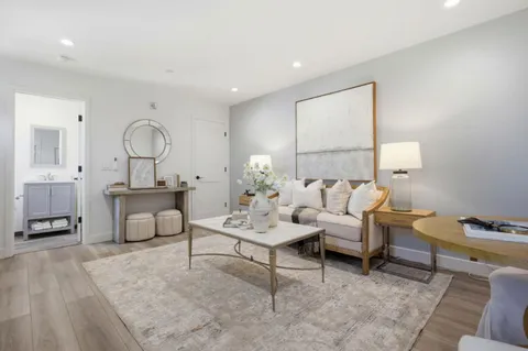 a living room with furniture and a lamp