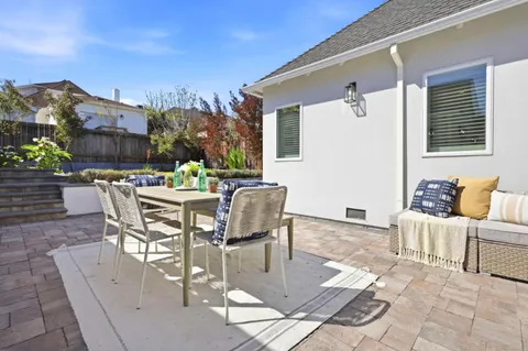 a view of a patio with a table and chairs