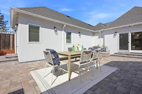 a view of a dinning table and chairs in the patio