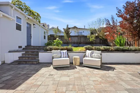 a view of a patio with couches and a fire pit