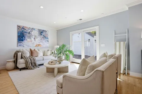 a living room with furniture and a potted plant
