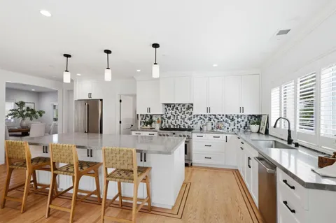 a large kitchen with lots of counter space and sink