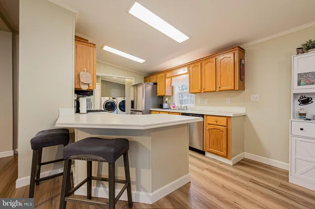 a kitchen with a sink cabinets and wooden floor