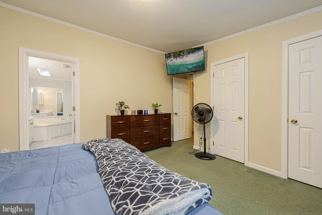 a bedroom with a bed and cabinets