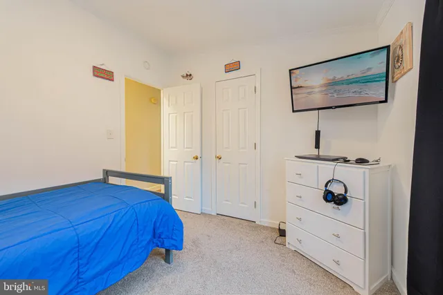 a bedroom with a bed and a dresser