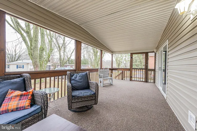 a bedroom with furniture and large windows