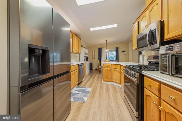 a kitchen with stainless steel appliances granite countertop a stove and a refrigerator