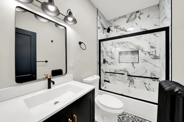 a bathroom with a sink a toilet and mirror