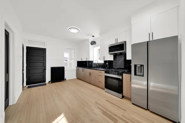 a large kitchen with a refrigerator and a stove