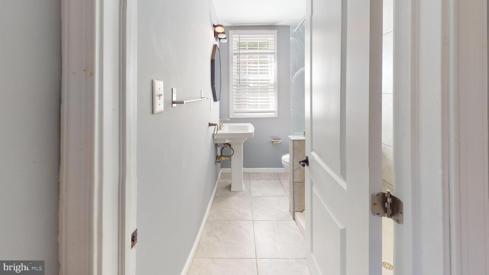 2203 Washington Avenue, Unit 102 Silver Spring, MD 20910 - Photo 12 of 13 a bathroom with a sink a toilet and shower