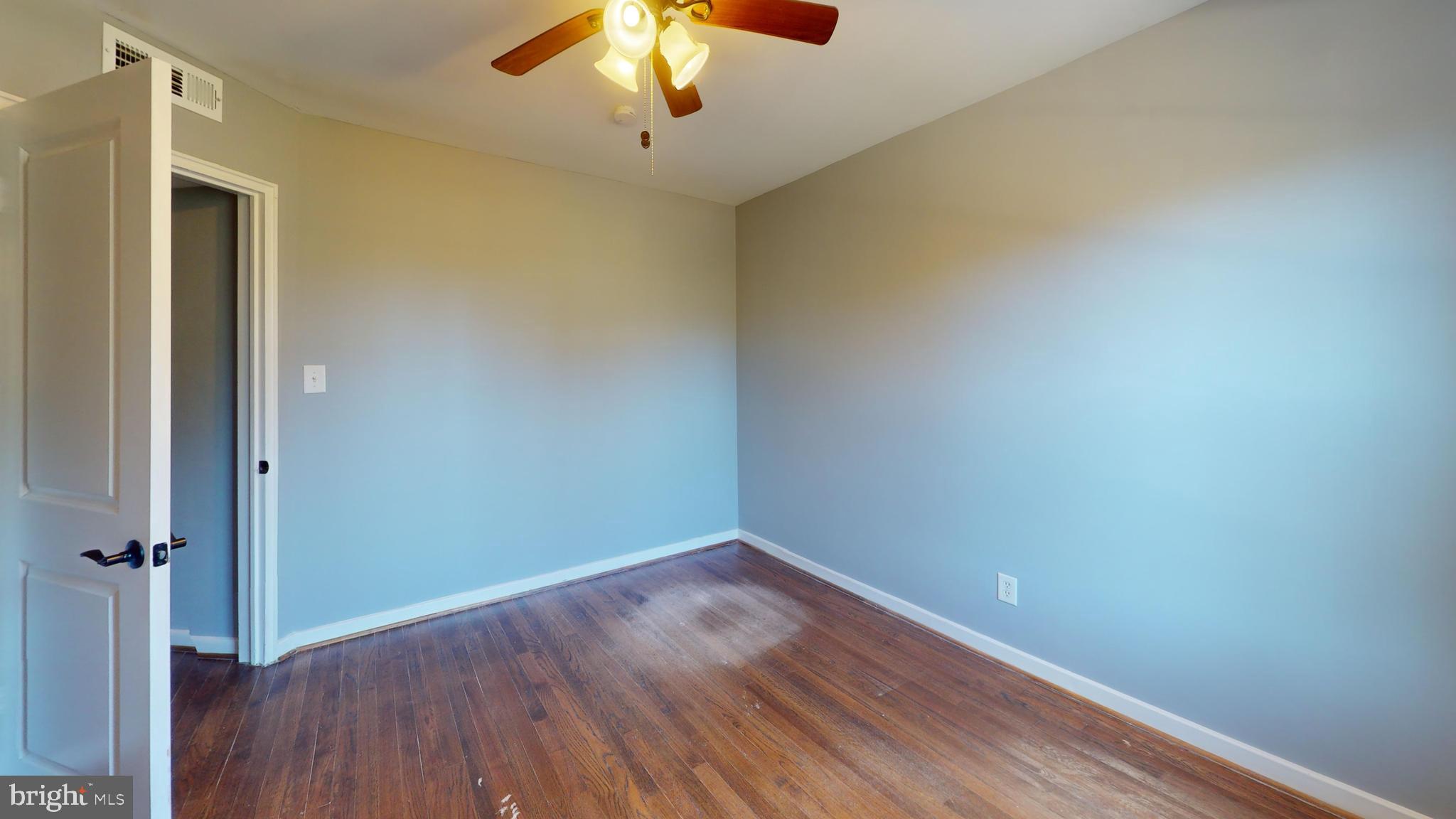 2203 Washington Avenue, Unit 102 Silver Spring, MD 20910 - Photo 5 of 13 an empty room with a hardwood and ceiling fan