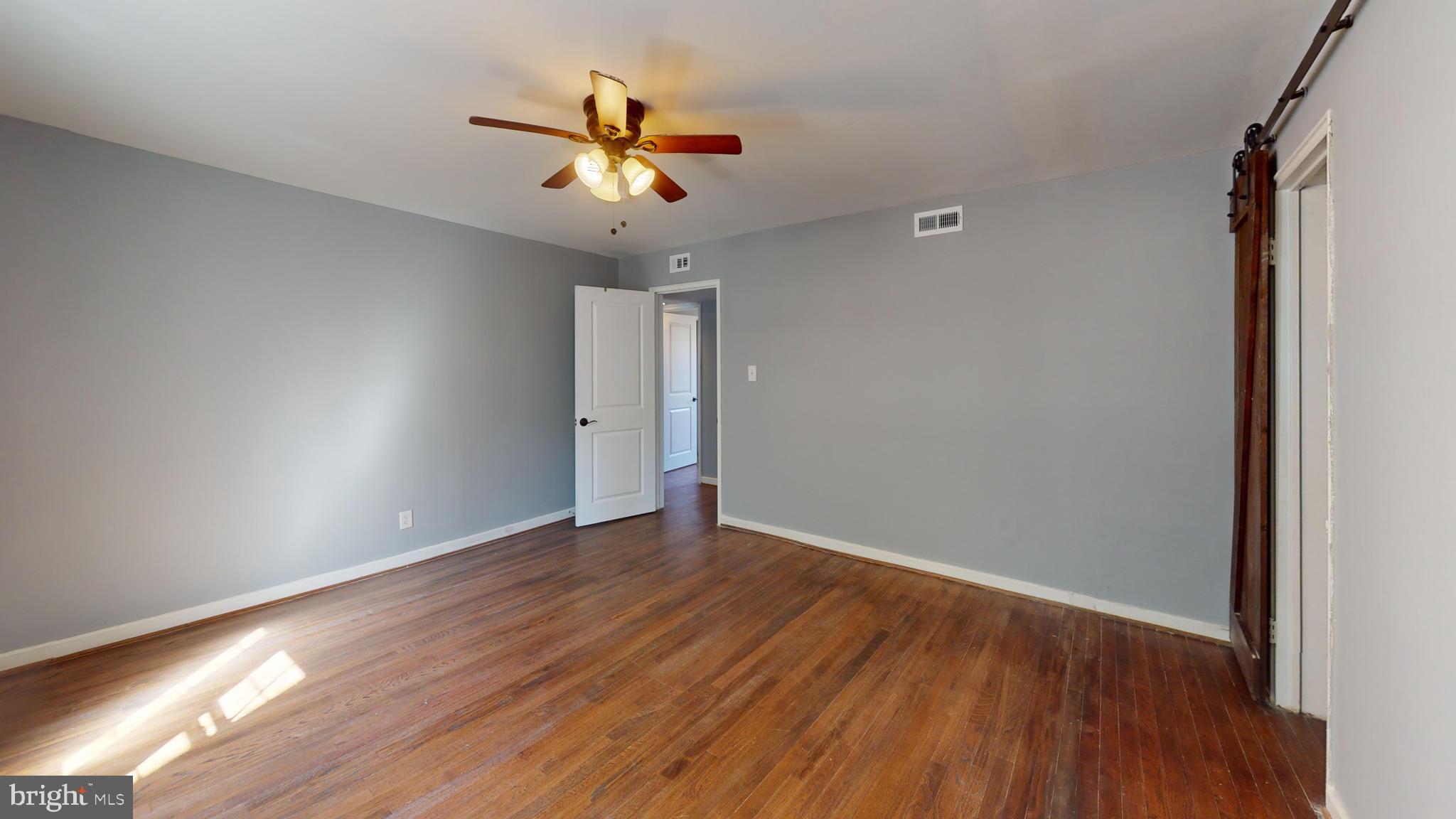 2203 Washington Avenue, Unit 102 Silver Spring, MD 20910 - Photo 8 of 13 wooden floor in an empty room with a window