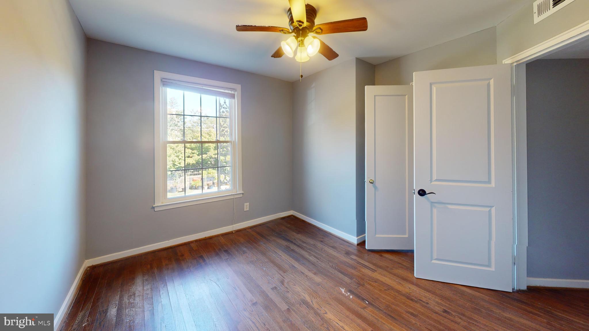2203 Washington Avenue, Unit 102 Silver Spring, MD 20910 - Photo 9 of 13 wooden floor in an empty room with a window
