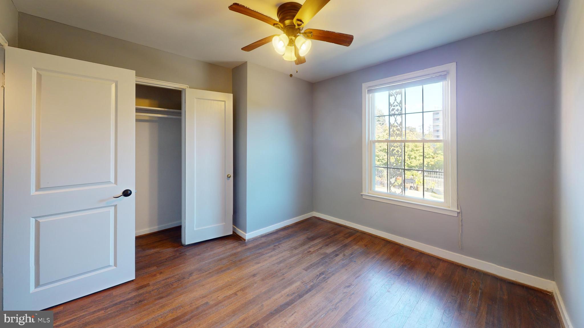 2203 Washington Avenue, Unit 102 Silver Spring, MD 20910 - Photo 10 of 13 a view of an empty room with window and wooden floor
