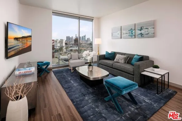 a living room with furniture and a large window
