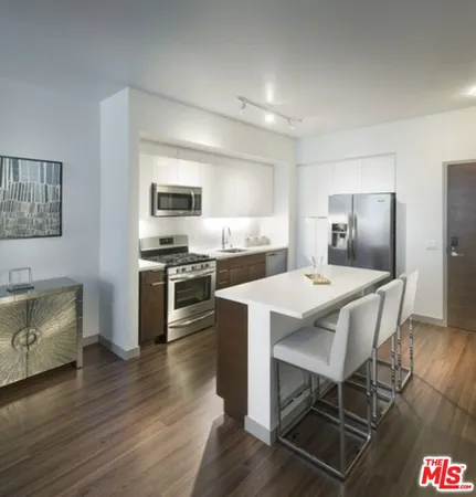 a kitchen with a dining table and chairs