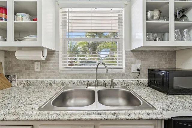 a kitchen with a sink and cabinets