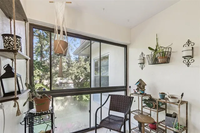 a view of a living room with furniture and floor to ceiling windows