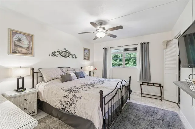 a bedroom with a large bed and a chandelier