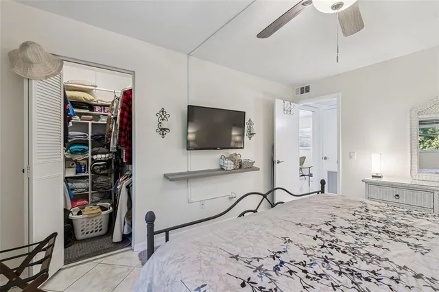 a bedroom with furniture and a flat screen tv