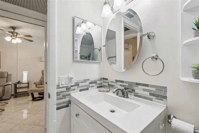 a bathroom with a sink vanity and mirror