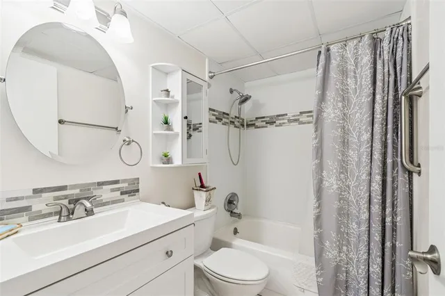 a bathroom with a sink toilet tub and shower