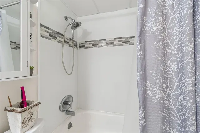 a bathroom with a shower and a shower