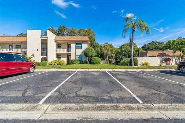 a view of a street with a cars parked in front of it