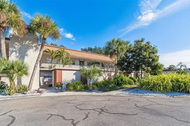 front view of house with a yard and potted plants