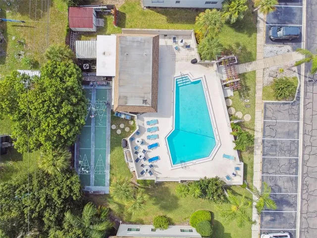 aerial view of a house with a yard and potted plants