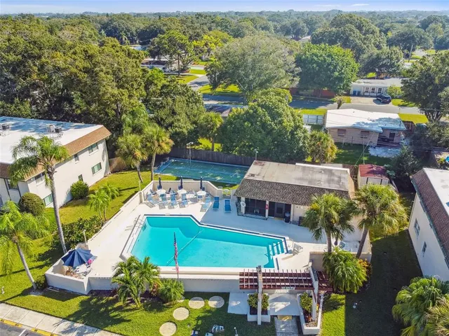 an aerial view of a house with a garden and lake view