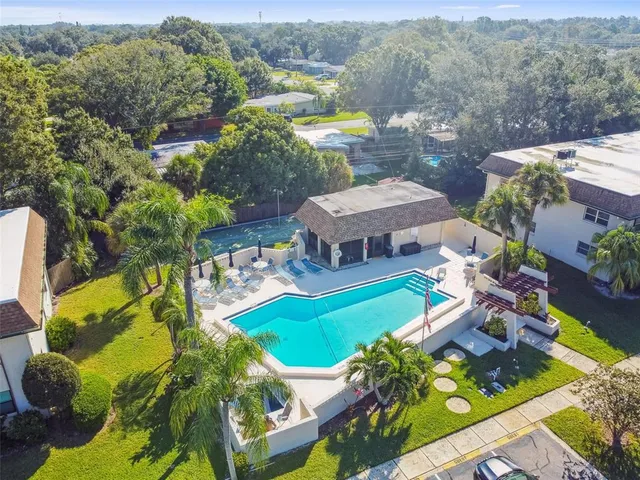 an aerial view of a house with swimming pool garden and patio